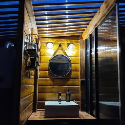 a bathroom with a sink and a mirror at Le Wigwam du Fassac in Saint-Julien-du-Puy