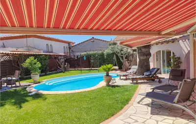 a swimming pool in a yard with an orange roof at Cozy Home In Puisserguier in Puisserguier
