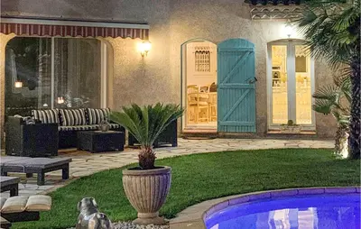 a house with a yard with a pool and a patio at Cozy Home In Puisserguier in Puisserguier