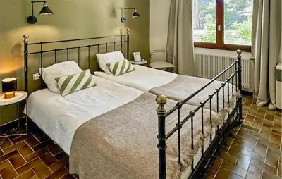 a bedroom with a large bed with white sheets and pillows at Nice Home In Cesseras With Wifi in Cesseras