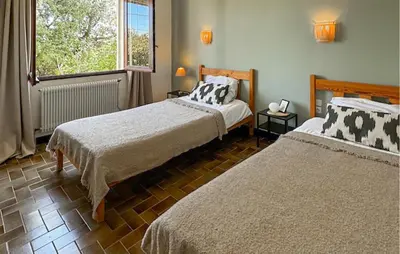 a bedroom with two beds and a window at Nice Home In Cesseras With Wifi in Cesseras
