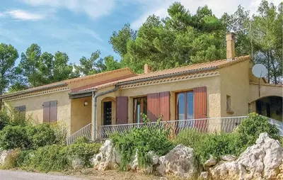 a small house with a rock in front of it at Nice Home In Cesseras With Wifi in Cesseras