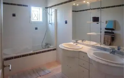 a white bathroom with a sink and a shower at Beautiful Home In Prades-Sur-Vernazobre in Prades-sur-Vernazobre