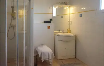a white bathroom with a sink and a shower at Beautiful Home In Prades-Sur-Vernazobre in Prades-sur-Vernazobre