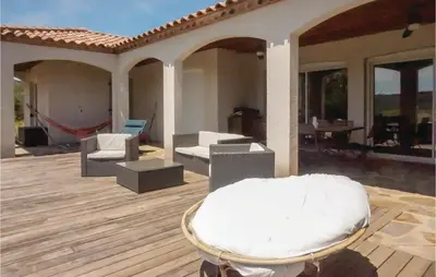 a wooden deck with a chair on a house at Beautiful Home In Prades-Sur-Vernazobre in Prades-sur-Vernazobre