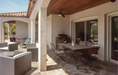 a dining room with a table and chairs on a patio at Beautiful Home In Prades-Sur-Vernazobre in Prades-sur-Vernazobre