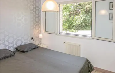 a bedroom with a bed and a window at Nice Home In Caunes Minervois With Wifi in Caunes-Minervois