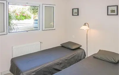 a bedroom with two beds and a window at Nice Home In Caunes Minervois With Wifi in Caunes-Minervois