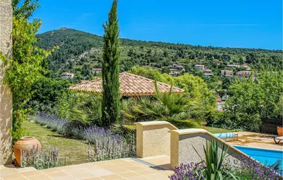 a villa with a swimming pool and a garden at Nice Home In Caunes Minervois With Wifi in Caunes-Minervois