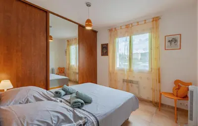 a bedroom with a bed and a large mirror at Gorgeous Home In Cessenon Sur Orb in Cessenon