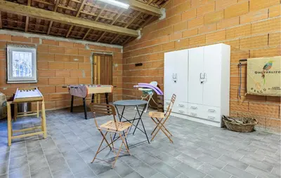 a room with a table and chairs and a refrigerator at Gorgeous Home In Cessenon Sur Orb in Cessenon