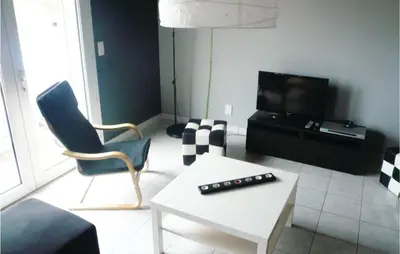 a living room with a couch and a table and a tv at 3 Bedroom Cozy Home In Quarante in Quarante