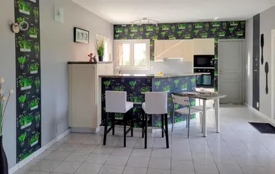 a kitchen with a table and chairs in a room at 3 Bedroom Cozy Home In Quarante in Quarante