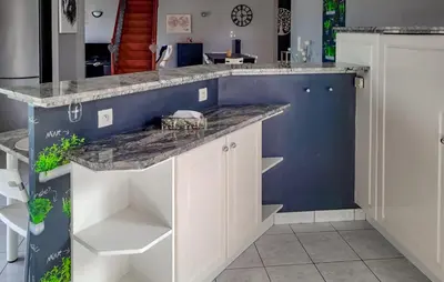 a kitchen with white cabinets and a blue wall at 3 Bedroom Cozy Home In Quarante in Quarante