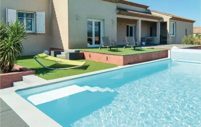 a swimming pool in the backyard of a house at 3 Bedroom Cozy Home In Quarante in Quarante