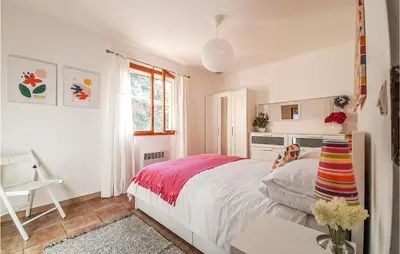 a bedroom with a bed and a desk and a window at Amazing Home In Cruzy in Cruzy