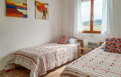 a bedroom with two beds and a window at Amazing Home In Cruzy in Cruzy