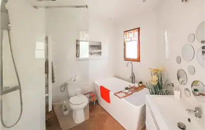 a bathroom with a tub and a toilet and a sink at Amazing Home In Cruzy in Cruzy