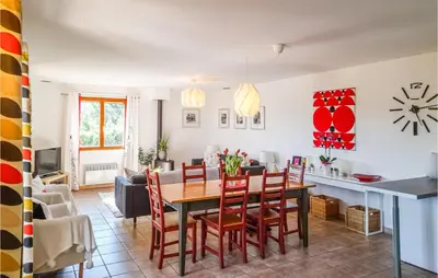 a dining room and living room with a table and chairs at Amazing Home In Cruzy in Cruzy