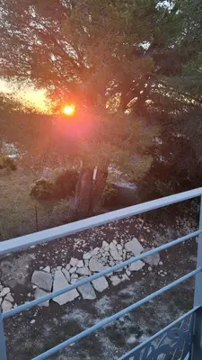 a view of the sun setting over a field at Le Studio des 3 Moulins in Sigean
