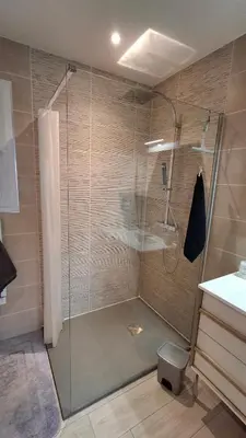 a shower with a glass door in a bathroom at Le Studio des 3 Moulins in Sigean