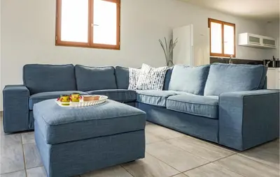 a blue couch and two chairs in a living room at 3 Bedroom Cozy Home In Caunes Minervois in Caunes-Minervois