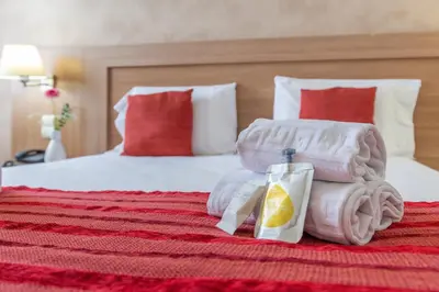 a hotel room with a bed with towels on it at Brit Hotel Confort Castres in Castres