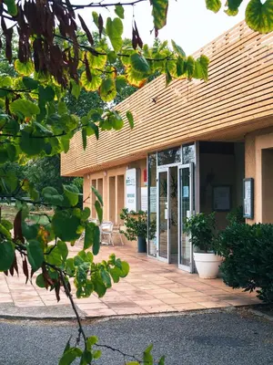 an entrance to a building with a glass door at Brit Hotel Confort Castres in Castres