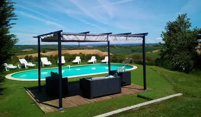 a swimming pool with a gazebo and chairs at Domaine De Polfages in Villautou