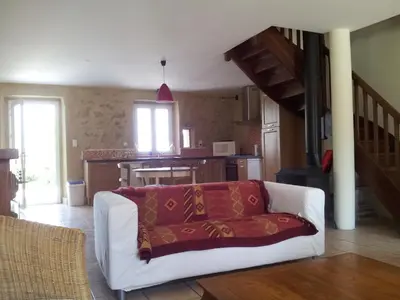 a living room with a white couch with a red blanket at Domaine De Polfages in Villautou