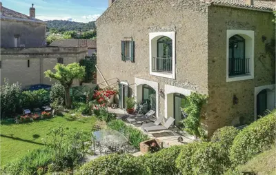 an external view of a house with a garden at 5 Bedroom Nice Home In Azillanet in Azillanet