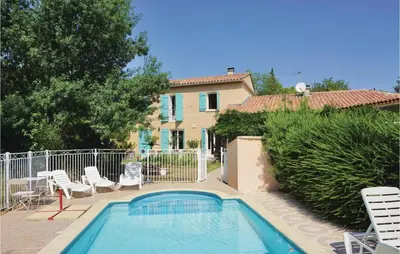a swimming pool with chairs and a house at Amazing Home In Prades Sur Vernazobre in Prades-sur-Vernazobre