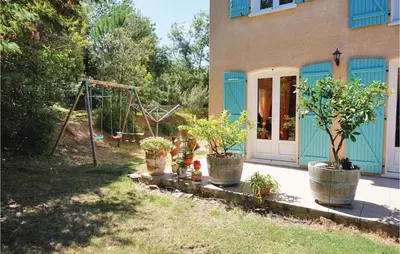 a house with potted plants and a swing at Amazing Home In Prades Sur Vernazobre in Prades-sur-Vernazobre