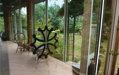 a screened in porch with a view of a garden at Amazing Home In Prades Sur Vernazobre in Prades-sur-Vernazobre