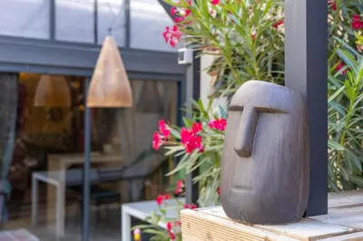 a wooden object sitting on top of a table with flowers at studio domloc in Carcassonne