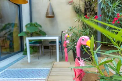 a pink flamingo is standing in a garden at studio domloc in Carcassonne
