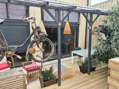 a bike hanging from a pergola on a patio at studio domloc in Carcassonne