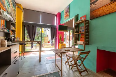 a kitchen with colorful walls and a table and chairs at studio domloc in Carcassonne