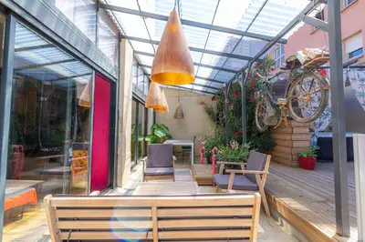 a patio with chairs and a table and a window at studio domloc in Carcassonne