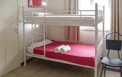 two bunk beds in a room with two rolls of toilet paper at Lovely Home In Puisserguier With Wifi in Puisserguier