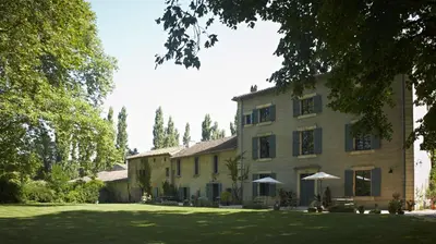 a large house with a lawn in front of it at Chambres d'hôtes du Domaine de Bonnery in Caucalières