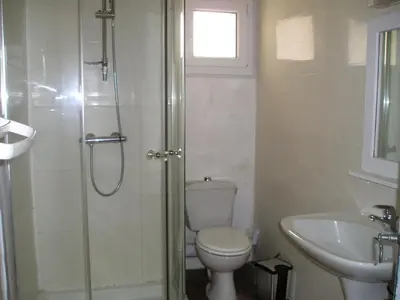 a bathroom with a shower and a toilet and a sink at GITE MAMIE LAURENCE in Gruissan