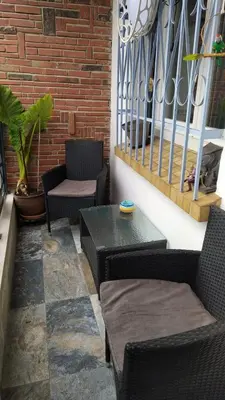 a patio with chairs and a table and a brick wall at Casa Del Castell in Carcassonne