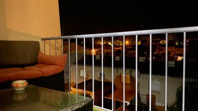 a balcony with a view of a city at night at Casa Del Castell in Carcassonne
