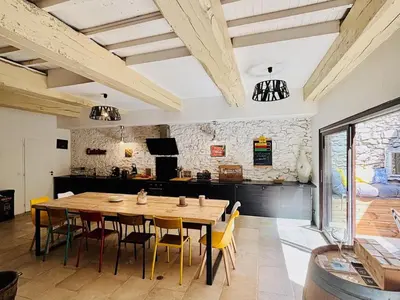 a dining room with a wooden table and chairs at Olonzac Escape Pool & Charm in Olonzac