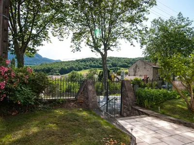a gate to a garden with a view at Au Petit Verger in Puivert