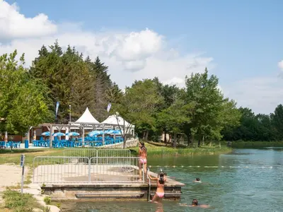 a group of people in the water at a lake at Au Petit Verger in Puivert