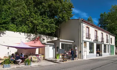 a group of people sitting outside of a building at Au Petit Verger in Puivert