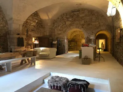 a living room with a couch and a table at La Manufacture Royale 1739 in Montolieu