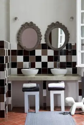 a bathroom with two sinks and mirrors at La Manufacture Royale 1739 in Montolieu